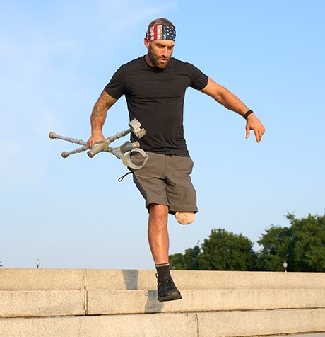 Earl holding his crutches while going down stairs.