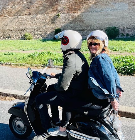 Brenda riding on a motor scooter