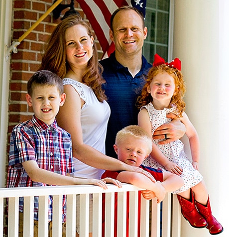 Kaitlin on a balcony with her husband and three children