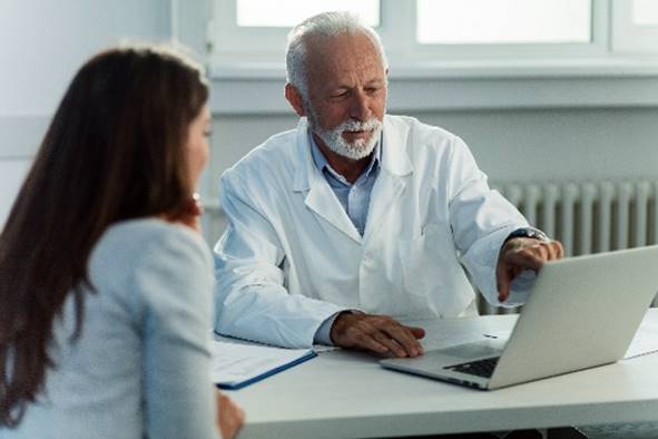 laboratory staff looking at a computer