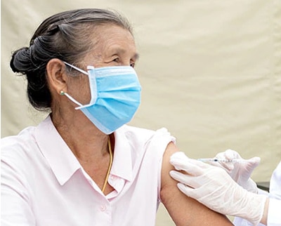 An elderly patient getting a COVID-19 vaccine.