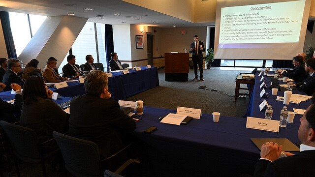 DSIIS Presenter speaking at a group of tables
