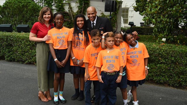 Surgeon General Jerome Adams poses with the “Youth of the Month” during the White House Sports and Fitness Day – a day to encourage kids to participate in sports and live an active lifestyle.