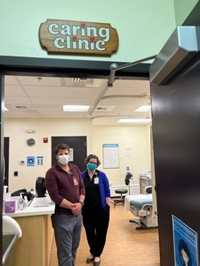 Two adults wearing masks inside of a clinic