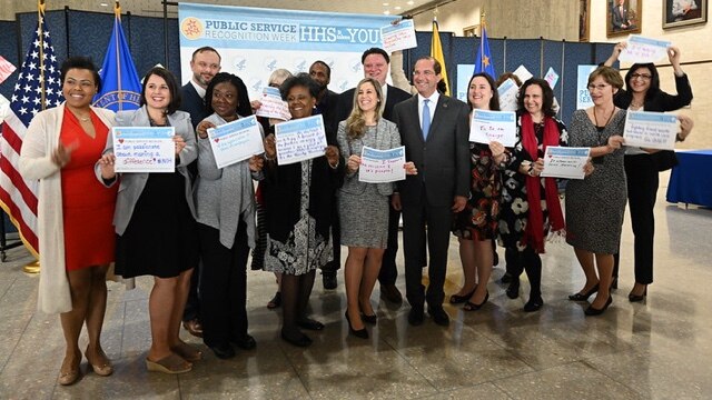Secretary Alex Azar with HHS employees holding up certificates during Public Service Recognition Week activities at HHS