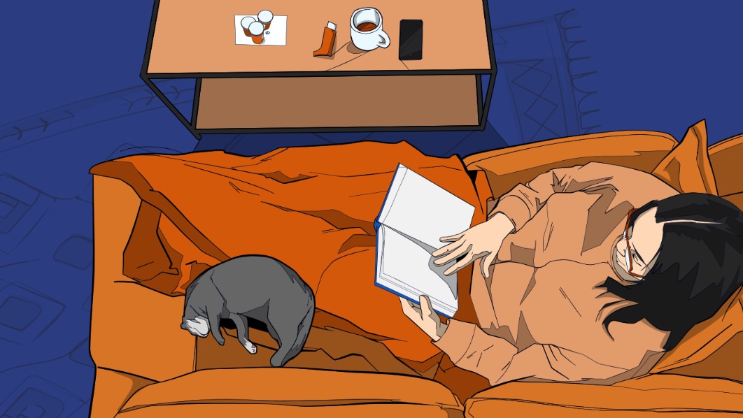 woman resting on the couch with a book and cat, with medication and an inhaler close by.