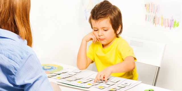 Boy points to activity cards