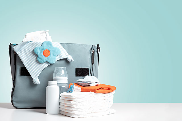 A diaper bag with diapers and other baby supplies