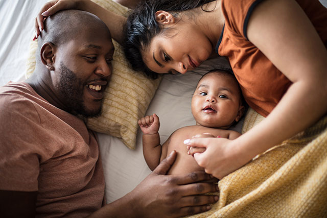 Parents cuddling their baby