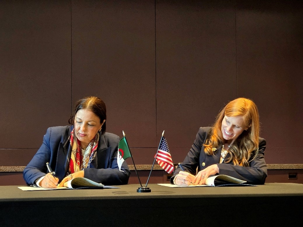 General Director of Multilateral Relations at the Ministry of Foreign Affairs, Baya Bensmail signs the Geneva Consensus Declaration on behalf of Algeria, alongside Director Bethany Kozma, Geneva Consensus Declaration Secretariat.