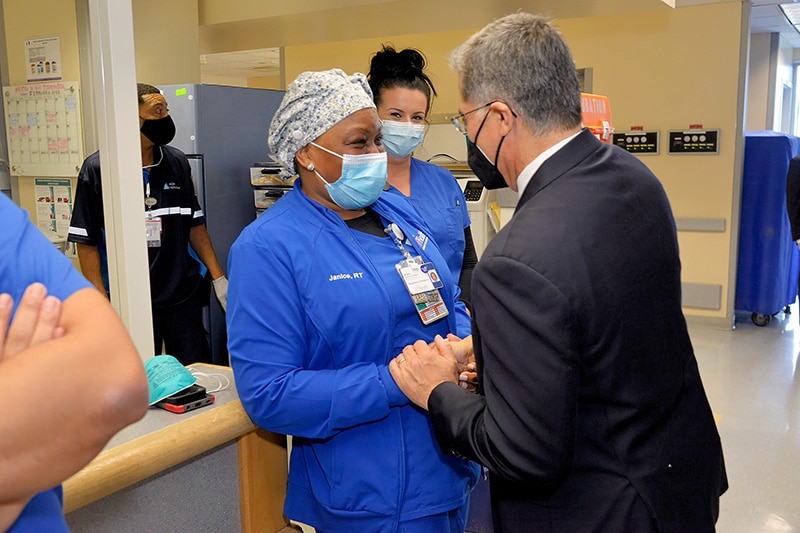 HHS Secretary Becerra greets a hospital worker at the UF Health Jacksonville