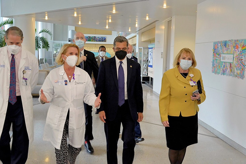 HHS Secretary Becerra walks with Dr. Linda Edwards, Dean UF Colleage of Medicine and Sandra McDonald, Director of Hospital Safety and Emergency Prepareness at UF Health Jacksonville on their way to participate in a roundtable with local Jacksonville hospital leaders