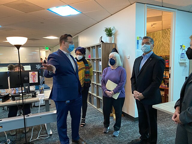 Secretary Becerra with group of people touring a crisis call center