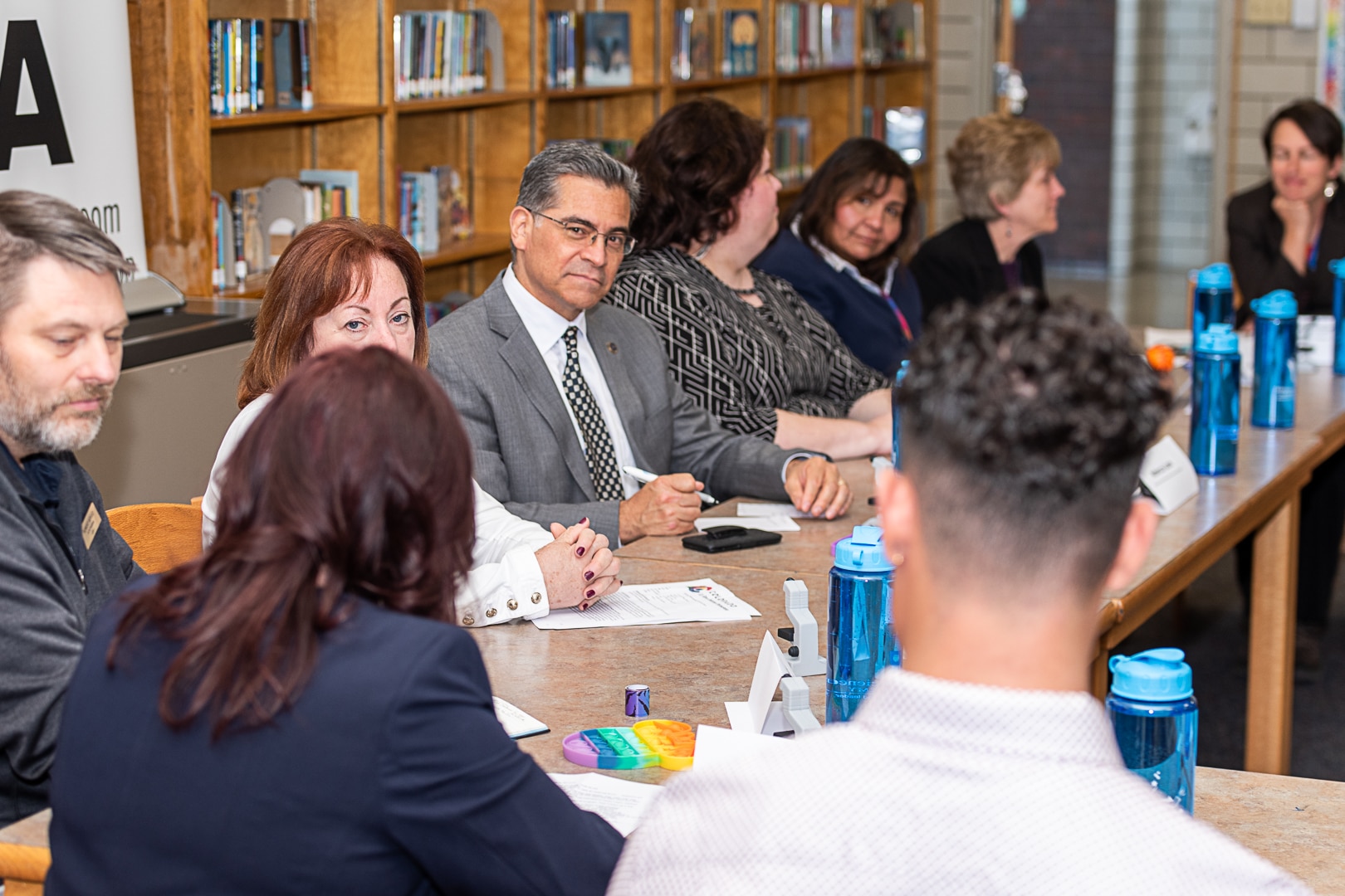 Secretary Becerra attending a roundtable event in school library