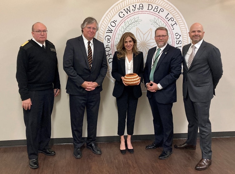 Regional Director Sima Ladjevardian holding a woven object and standing with four other adults during a visit to Cherokee Nation in Oklahoma.