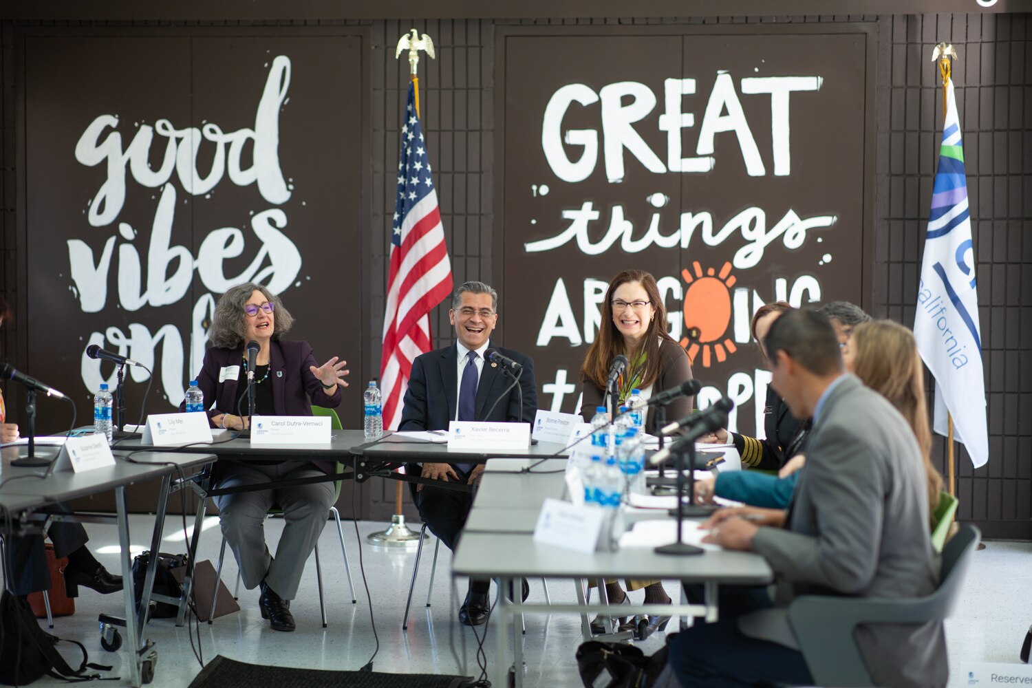 Secretary Becerra laughing with local leaders at roundtable event