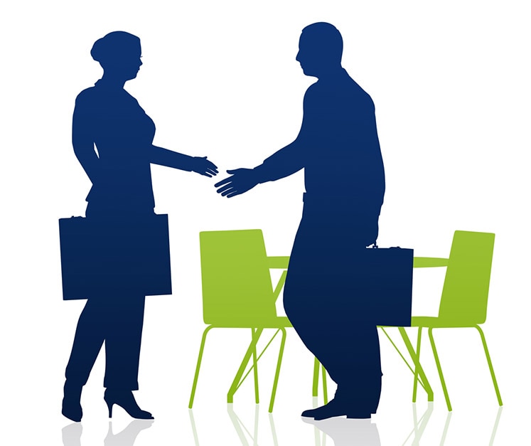 Dark blue graphic outline of two people one female one male shaking hands in front of a bright graphic of one table two chairs