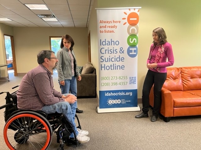A photo of HHS Region 10 Director Ingrid Ulrey at the Idaho Crisis & Suicide Hotline with Director Lee Flinn and Assistant Director George Austin.