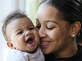 Woman kissing a baby