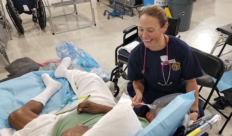 LT. Carin Molchan, RN, a nurse with the U.S. Public Health Service cares for a patient at a medical shelter in Clayton, NC. 