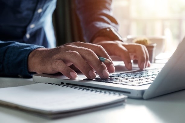 Man typing on laptop