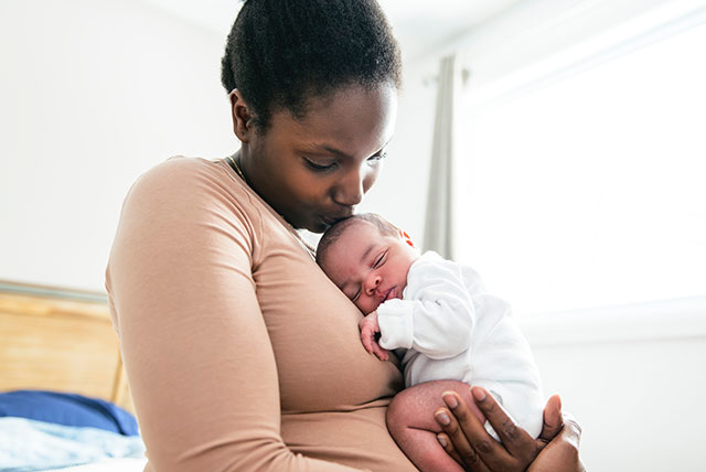 A mother hugging her newborn