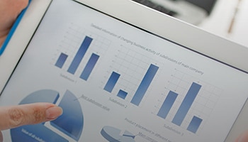 pie and bar charts on a tablet.