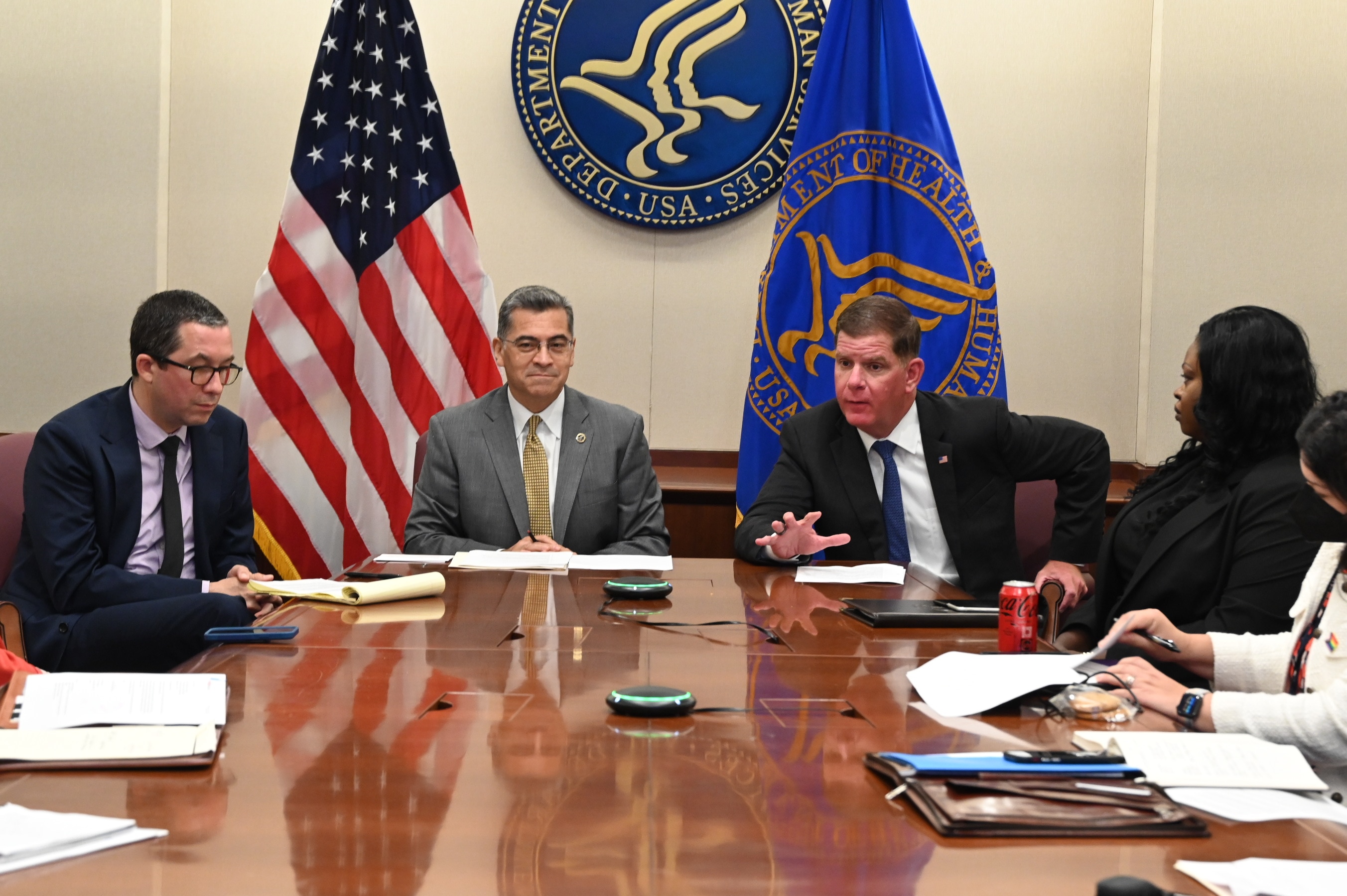 Secretary Becerra and Secretary Walsh seated with others at a large conference table during a meeting with health insurers to discuss birth control coverage