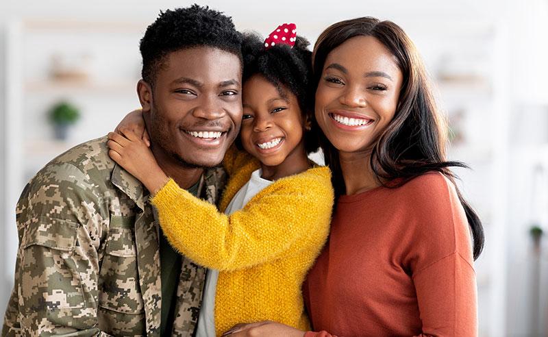 Portrait Of Happy Military Family, Black Soldier Father, Wife And Little Daughter Embracing Together