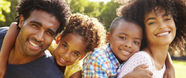 Smiling family playing together outside