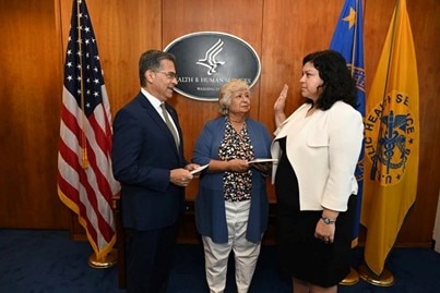 HHS Secretary Xavier Becerra, pictured with OCR Director Melanie Fontes Rainer and his mother.